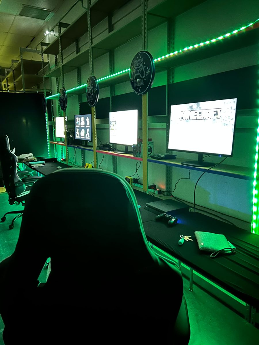The Discovery gaming room with screens and green lights